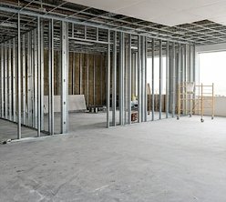 Metal stud framing laid out across an open commercial floor