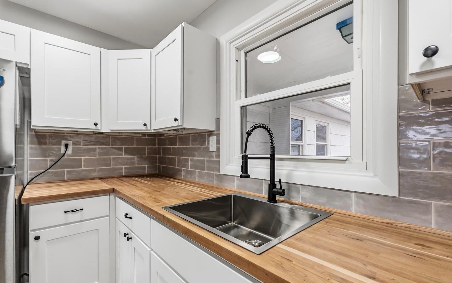 Kitchen with subway tile backsplash and new cabinets